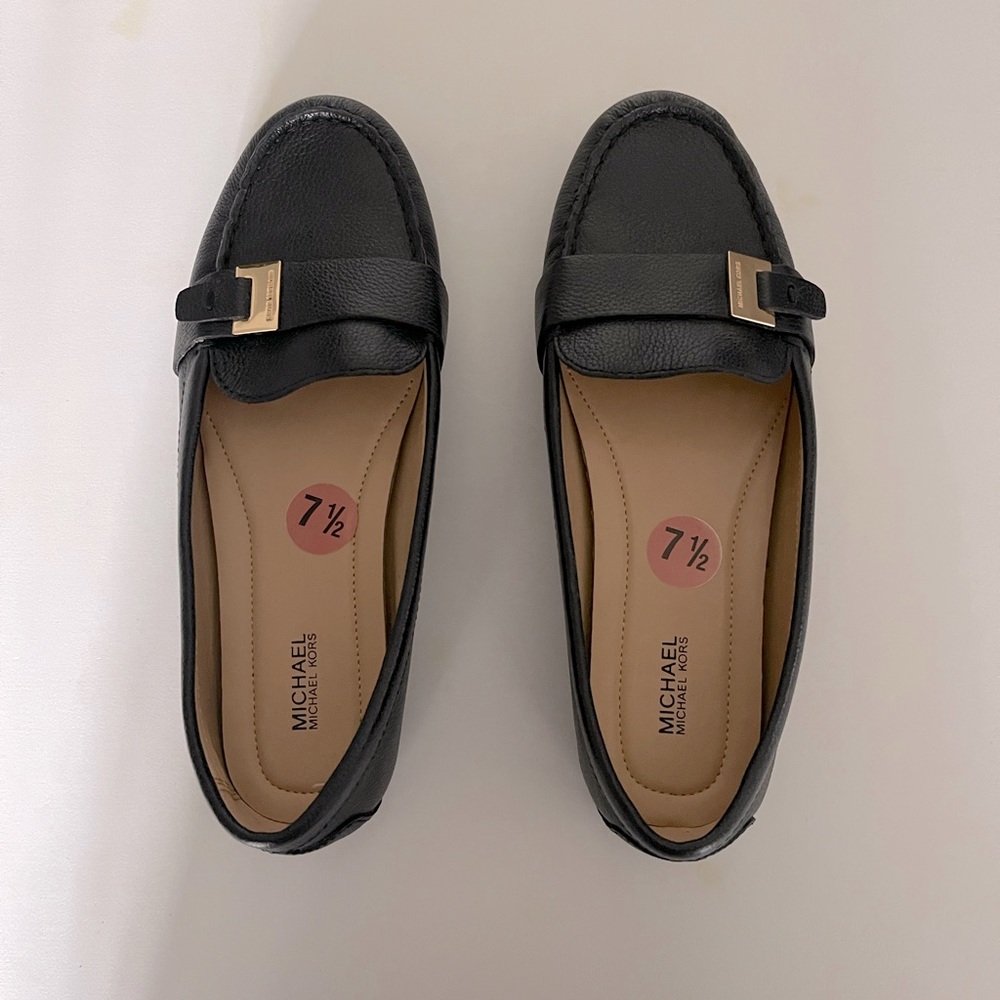 Women’s black leather loafers.